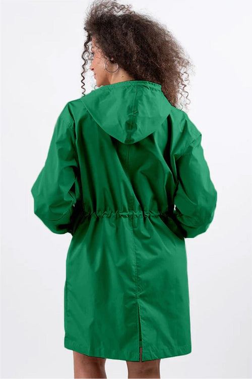 Woman wearing green oversized Rain Couture Windbreaker jacket with hood, back view