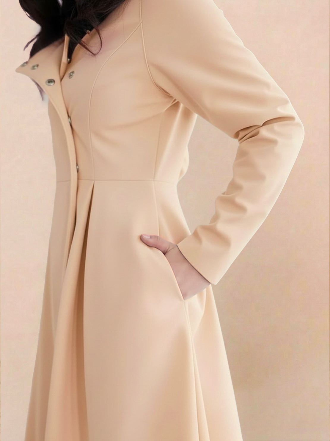 Water-repellent A-line hooded raincoat with belt, feminine fit, and insulated lining for warmth and style.