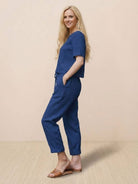 Woman wearing relaxed cotton linen set with short-sleeve top and straight-leg pants in monochrome tones