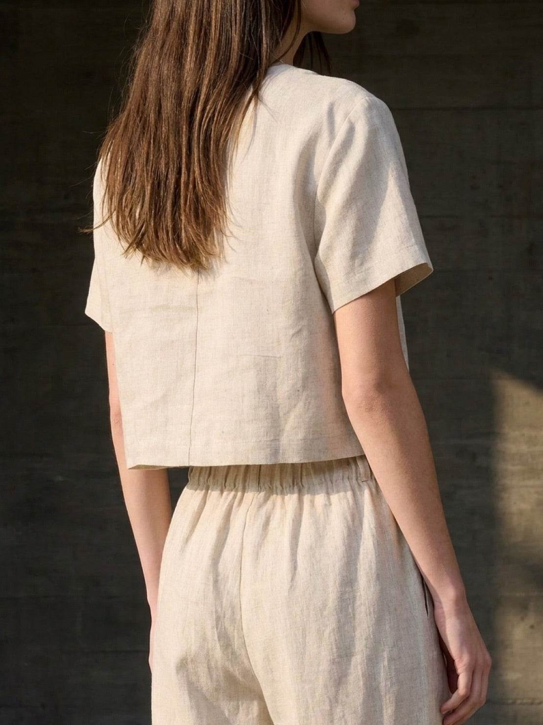 Lightweight 100% linen French top with V-neckline, short sleeves, and three-button front detail in relaxed boxy shape