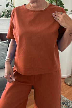 Rust-colored loose fit co-ord set with relaxed short-sleeve top and wide-leg trousers
