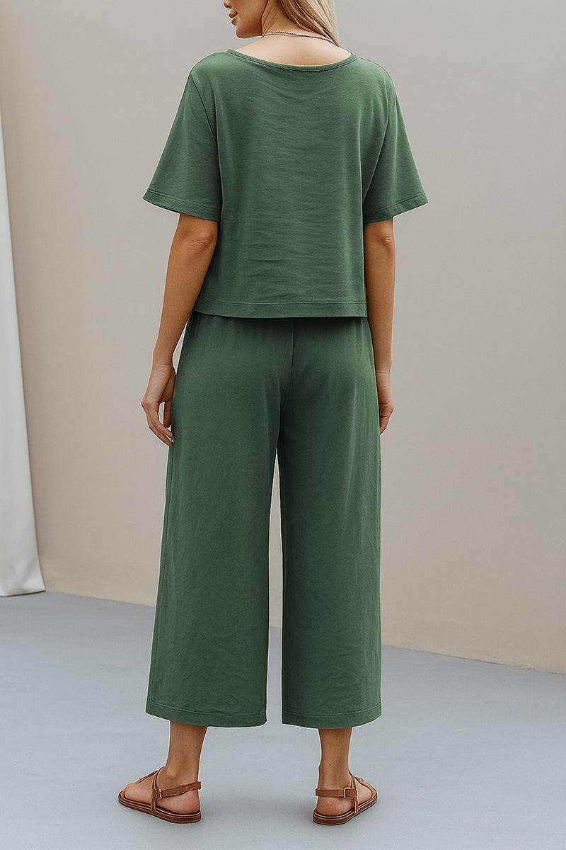 Woman wearing green loose fit co-ord set with wide-leg pants and short-sleeve top, back view