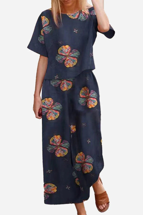 Loose fit co-ord set with floral print, wide-leg bottoms, and relaxed short-sleeve top in navy.