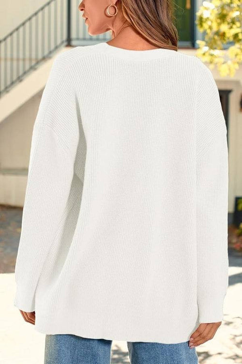 Relaxed fit oversized white knit cardigan on woman outdoors back view