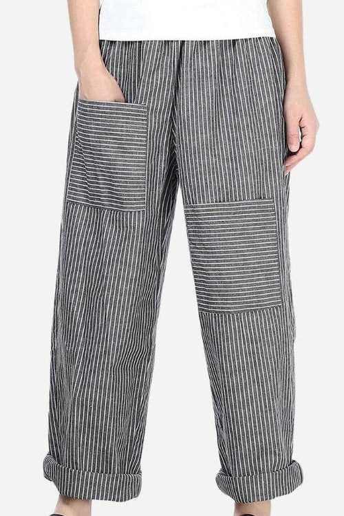 High waist striped comfort pants with large patch pockets and rolled cuffs on a female model