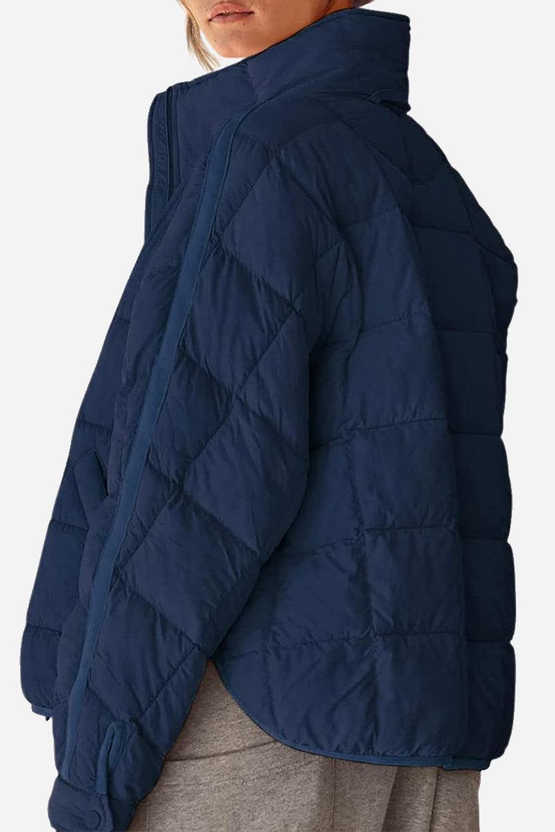 Woman wearing a lightweight puffer travel jacket styled for versatile, travel-ready comfort and warmth