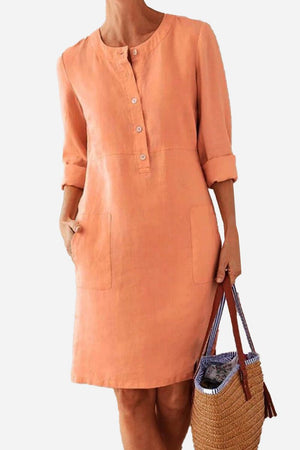Women’s peach cotton dress with 3/4 rolled sleeves, button front, and pockets in casual summer style