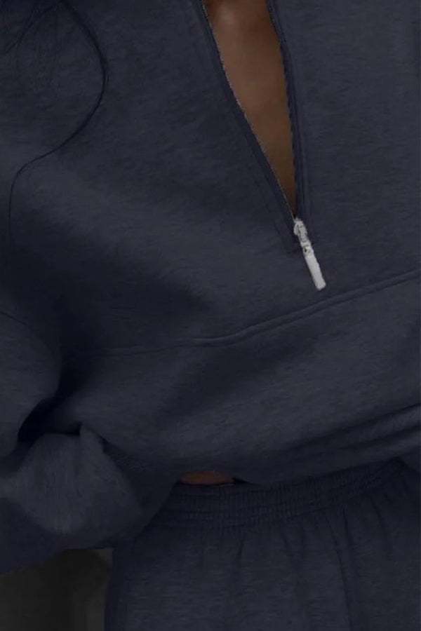 Close-up of dark cotton-blended two-piece tracksuit with high collar and zipper detail