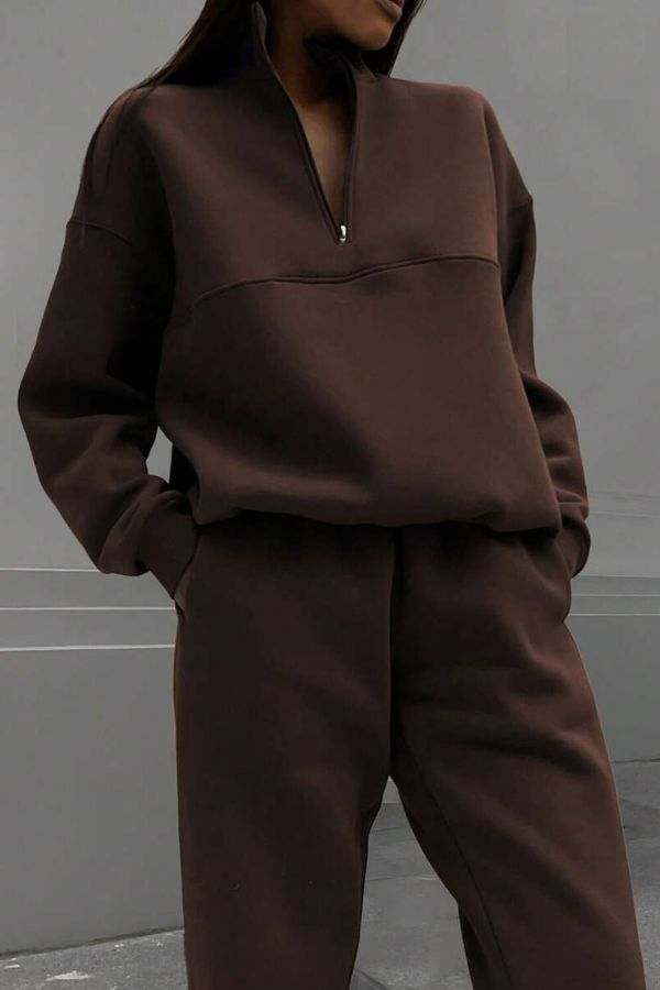 woman wearing brown cotton-blended two-piece tracksuit with high collar and deep zipper