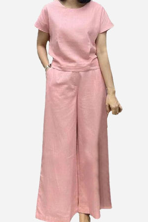 Woman wearing pink short-sleeved bell pants two-piece set with loose fit and minimalist design
