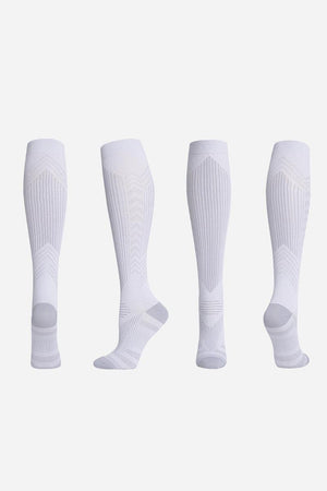 White premium compression socks shown from multiple angles for travel and leg support