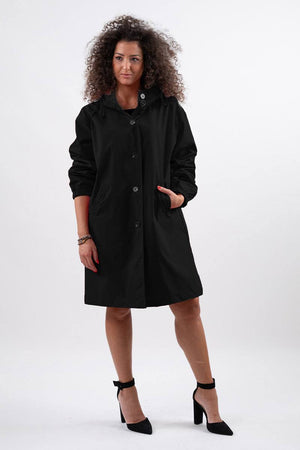 Travel-smart waterproof hooded windbreaker in black with adjustable hood and sleek design for elegant rain protection.