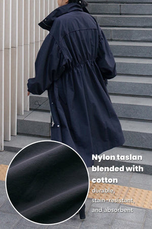 Back view of oversized cotton stain-resistant coat in navy, made from durable nylon taslan and cotton blend fabric.