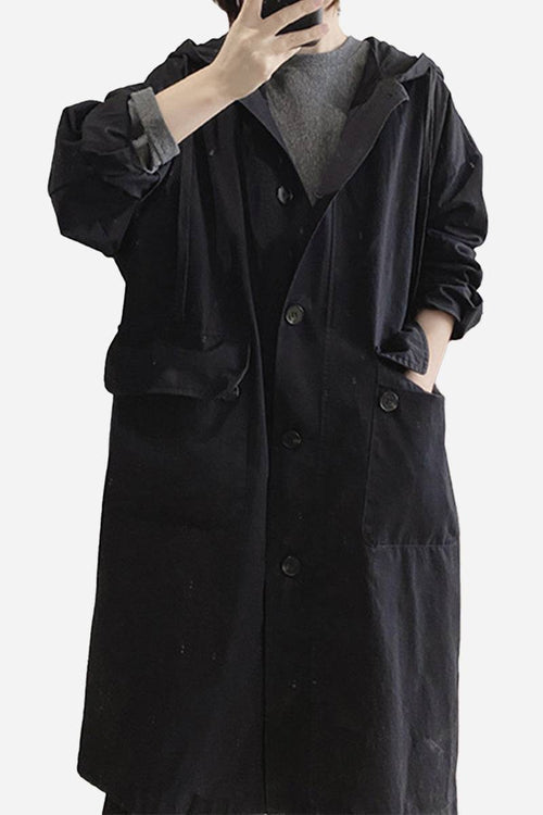 Black travel-ready hooded windbreaker with snap buttons and pockets, made of breathable 100% cotton, one size fits all.