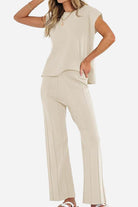 First Class Travel beige two-piece set with soft pleated pants and short sleeve top for stylish comfortable travel wear
