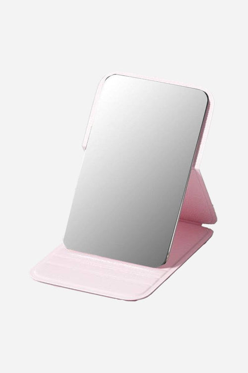 Compact travel pocket mirror with durable pink PU leather case and clear reflective surface for on-the-go touch-ups