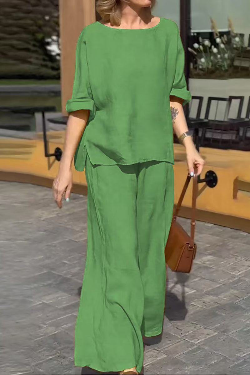 Woman wearing green 100% cotton two-piece set with round neck top and wide-leg pants outdoors.
