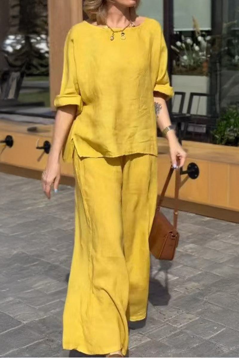 Woman wearing yellow 100 cotton two-piece set with wide-leg pants and rolled-up sleeve top outdoors