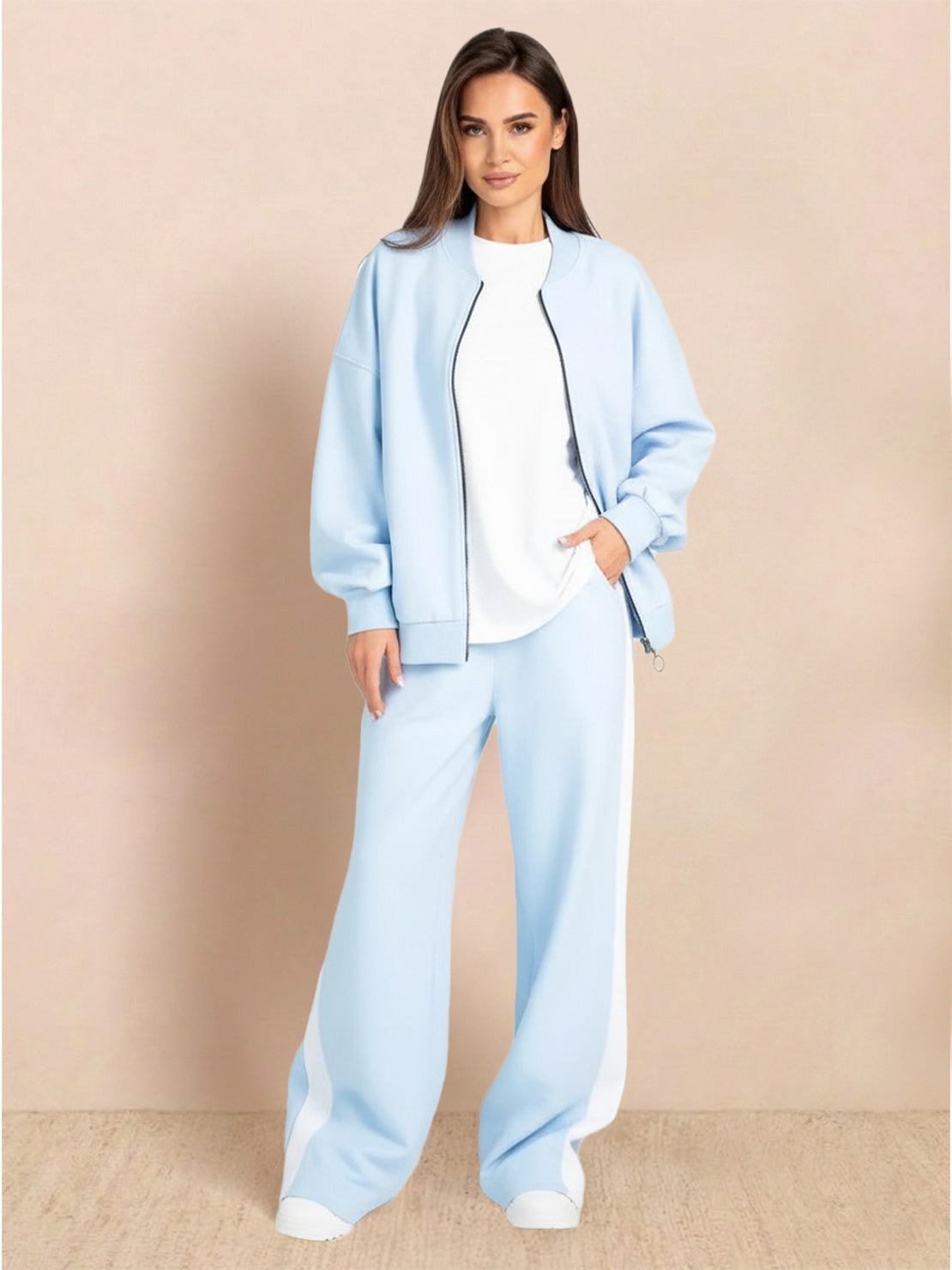 woman wearing easy airport lounge set with zip-front jacket and wide-leg pants standing on street