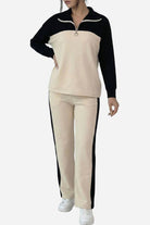 Woman wearing Colorblock Comfort Leisure Set with half-zip pullover and wide-leg pants in cream and black colors