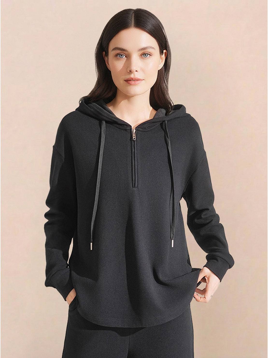 Woman wearing black lyocell-blend hooded set with zipper and drawstring hood