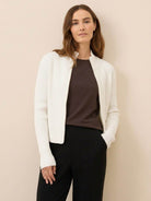 ribbed zip-up knit cardigan jacket with high neckline and fitted cuffs, soft stretch fabric, flattering slim fit, and vertical ribbing for elongating silhouette