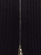 white ribbed zip-up knit cardigan jacket with high neckline and long sleeves on wooden hanger