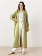 Long Australian Merino Wool cardigan with open front, patch pockets, and ribbed cuffs for layering in cooler seasons