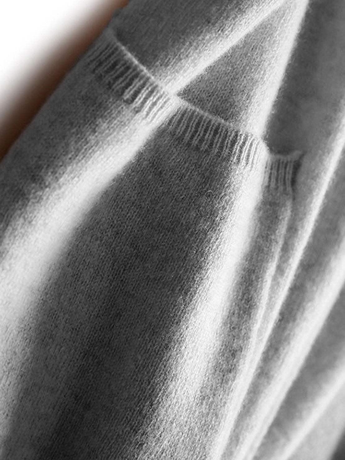 Longline open-front cardigan made from 100% Australian Merino Wool with front pockets and ribbed cuffs for natural temperature regulation.