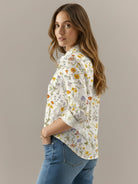 Women's floral button-down shirt with long roll-up sleeves and hip-length hem
