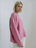 oversized crew neck knit sweater with drop shoulders and relaxed fit in neutral color