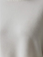 Oversized crew neck knit sweater with drop-shoulder sleeves and ribbed cuffs in neutral color