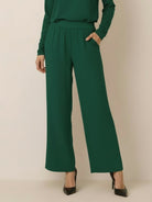 Woman wearing open-front three-piece co-ord with longline cardigan, tank top, and wide-leg trousers