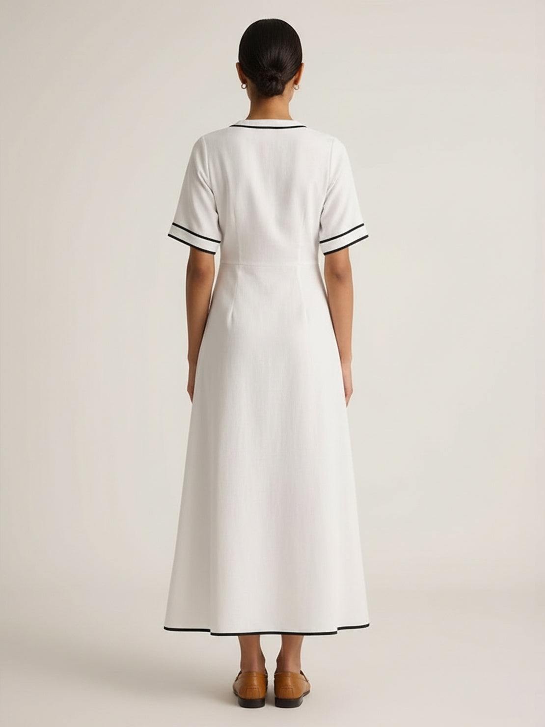 Woman wearing a knot-waist maxi dress with V-neckline and flowing skirt