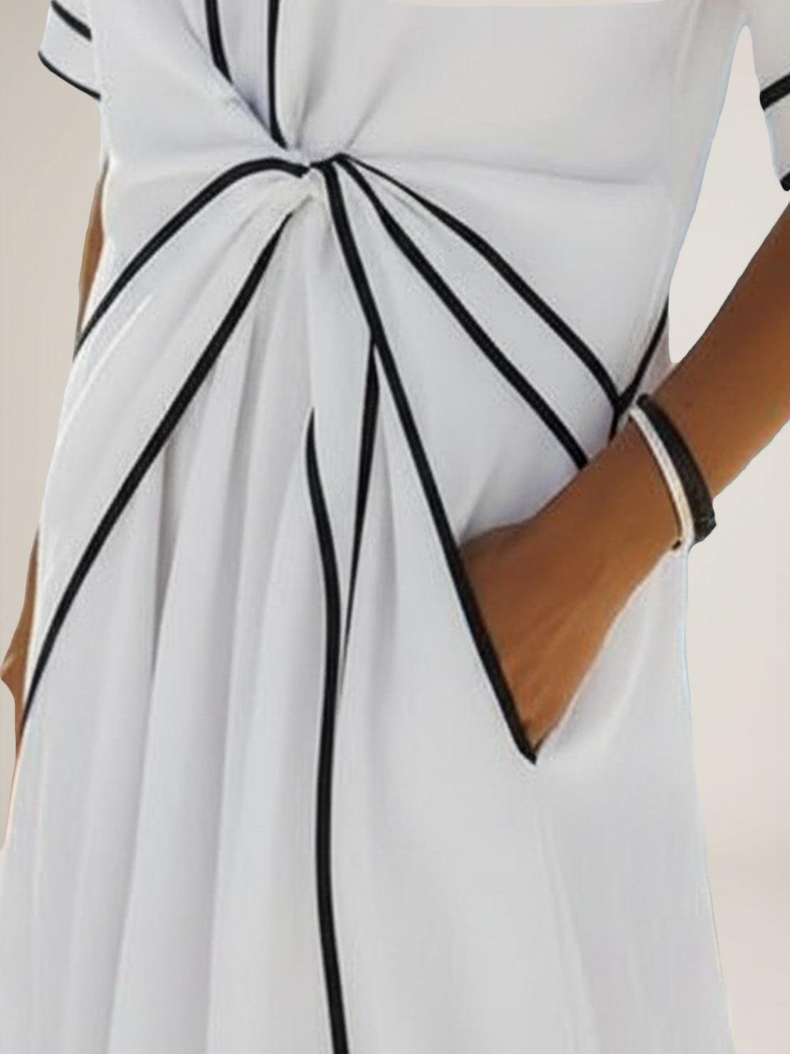 Woman wearing a flowing knot-waist maxi dress with V-neckline and batwing sleeves