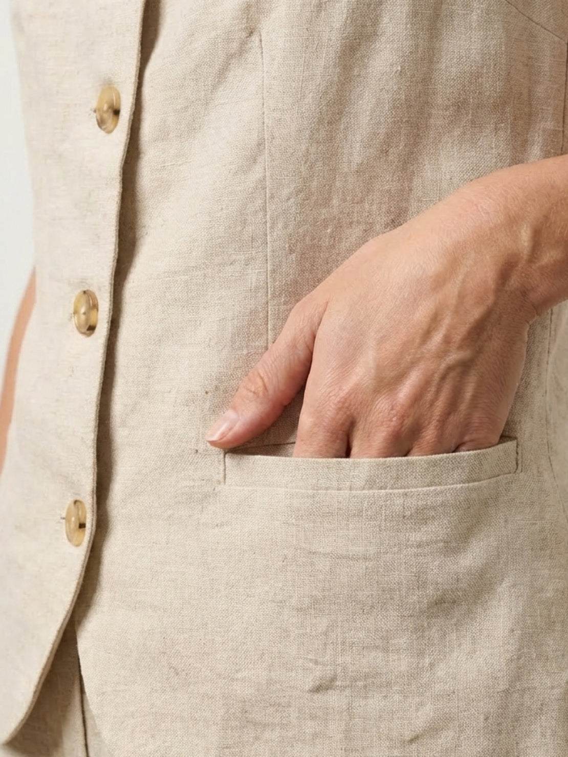 100% linen yarn-dyed vest with full button-front, square neckline, curved hem, and hip pockets