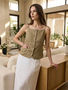 Lightweight 100% linen yarn-dyed vest with square neckline, full button-front, welt pockets, and curved hem