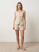 100% linen yarn-dyed vest with button-front, square neckline, and hip welt pockets