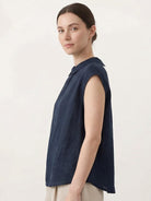 100% linen two-way button blouse with rounded Peter Pan collar and cap sleeves in relaxed A-line silhouette
