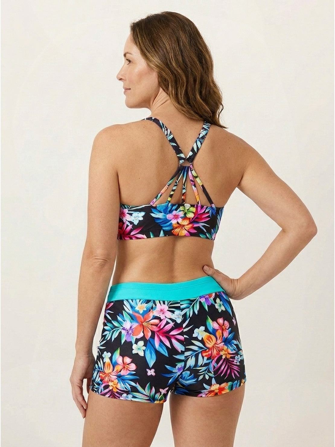 Three-piece open-back swim set with loose tank, racerback crop bra, and boy-short swim shorts.