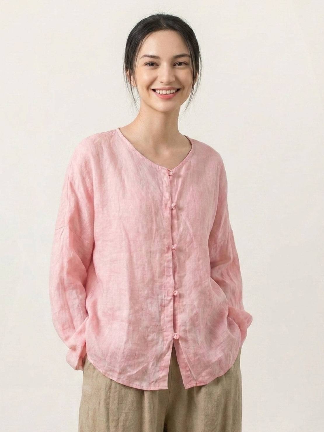 Oversized 100% linen blouse with frog-button closure, collarless neckline, long sleeves, and curved hem in lightweight semi-sheer fabric