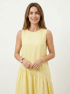 Lightweight cotton-linen summer midi dress with loose tiered skirt and round neckline in natural creasing fabric