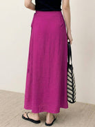 woman wearing asymmetrical wrap maxi skirt with side tie closure and flowing fabric