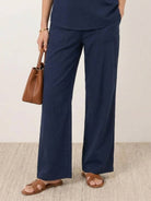 Mature woman wearing lightweight 100% linen top with V-neck, short sleeves, and three-button detail in relaxed boxy shape