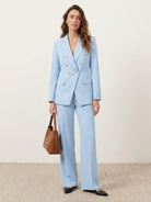 Double-breasted blazer with gold lion-head buttons and wide-leg trousers co-ord set in structured suiting fabric