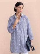 Oversized linen shirt in relaxed fit with back-pleat detail and button-up design