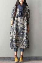 woman wearing blue Japanese porcelain print midi dress with 3/4 sleeves and oversized pockets standing indoors