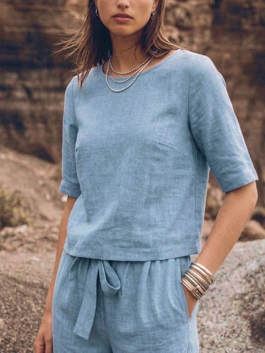 Woman wearing a breathable cotton linen set with relaxed short-sleeve top and straight-leg pants in monochrome tones
