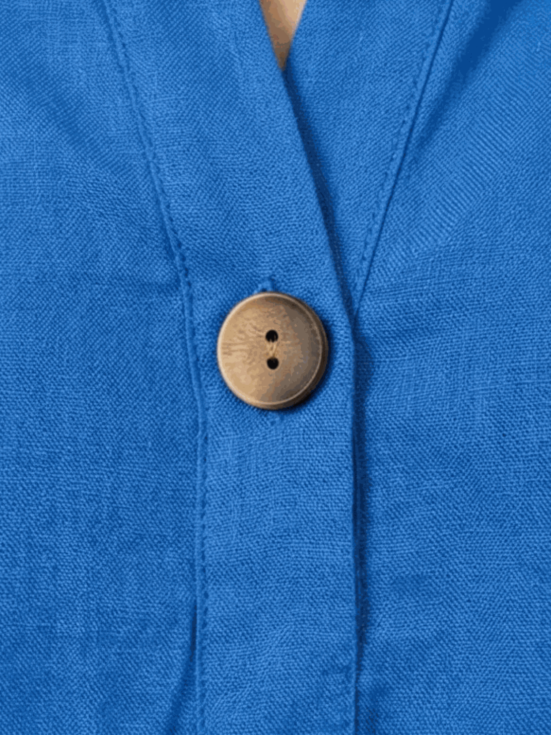 woman wearing pure linen age-defying shirt with button detail in soft coral color