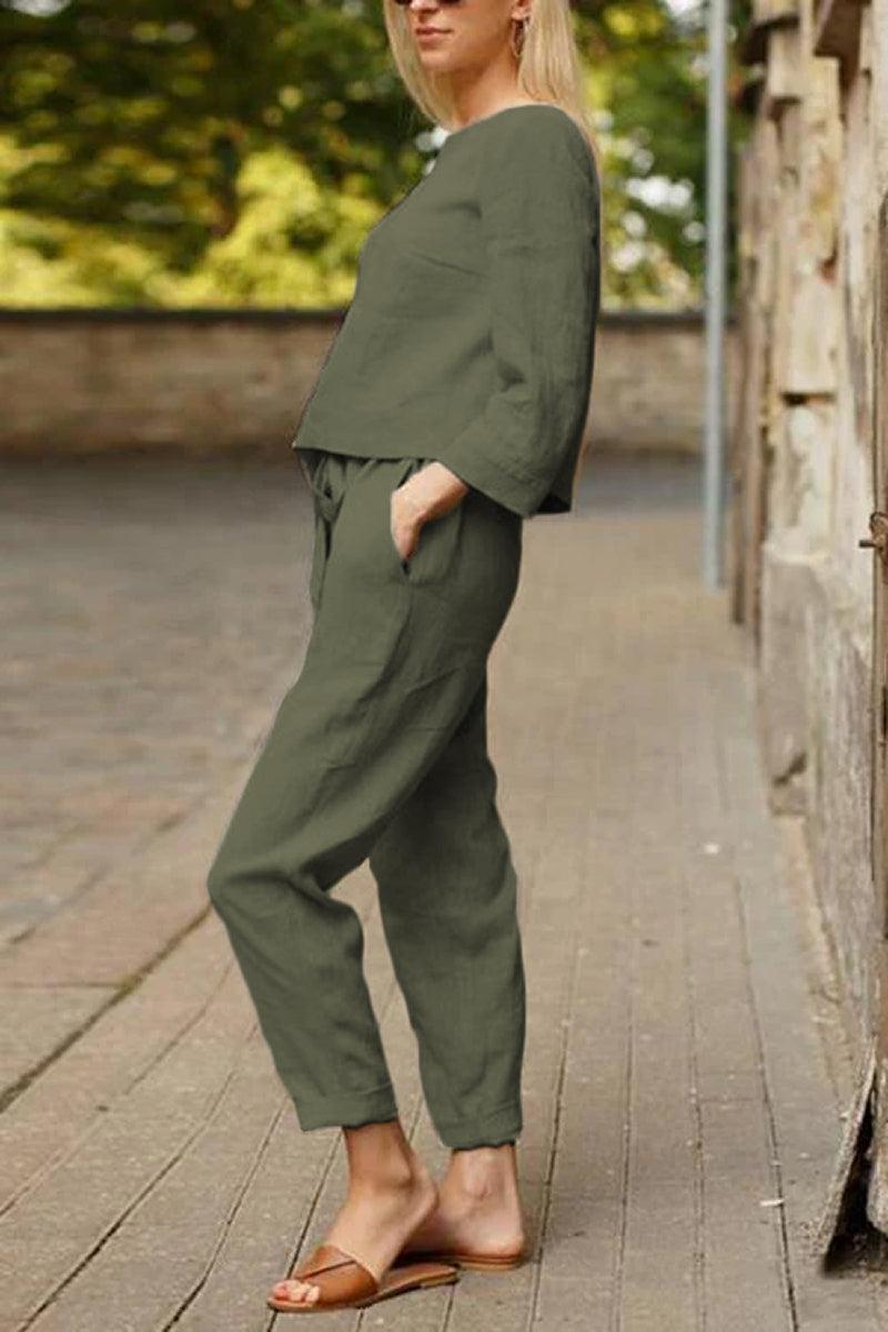 Woman wearing olive green cotton-linen monochrome relaxed longline top and wide-leg pants set outdoors